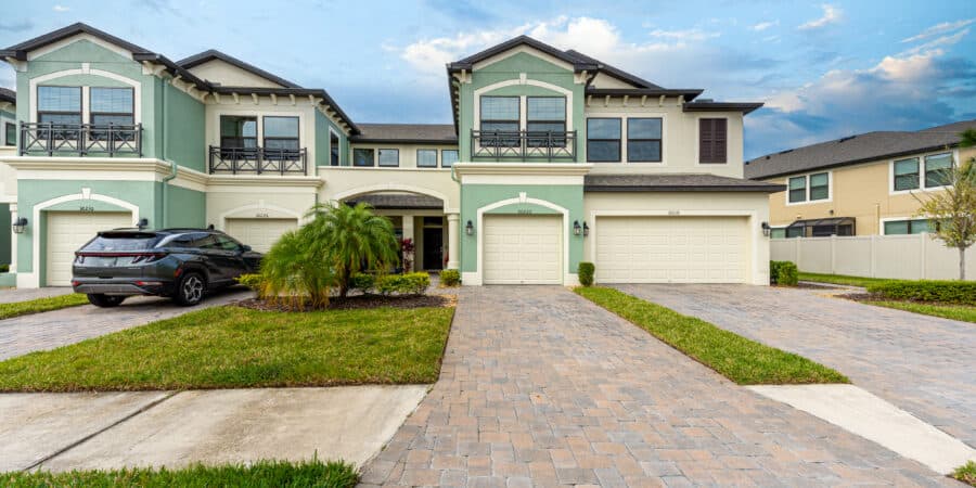 Elegant Tampa townhouse with a beautifully landscaped driveway and modern exterior design.