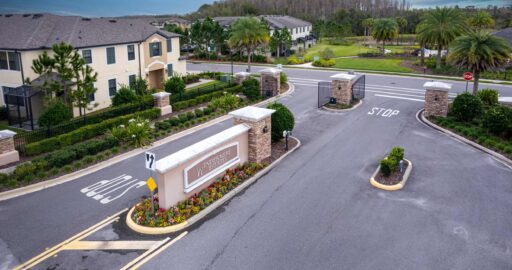 New residential community entrance with gated access and lush landscaping, Tampa Homes Sold.