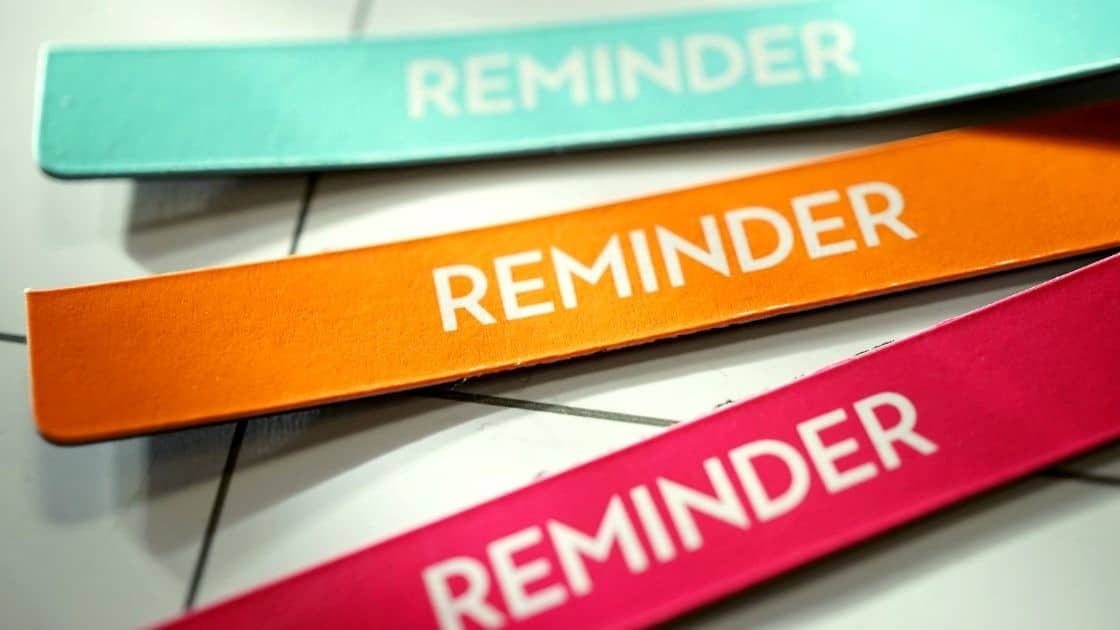 Colorful reminder sticky notes in pastel pink, orange, and teal for home organization and reminders.