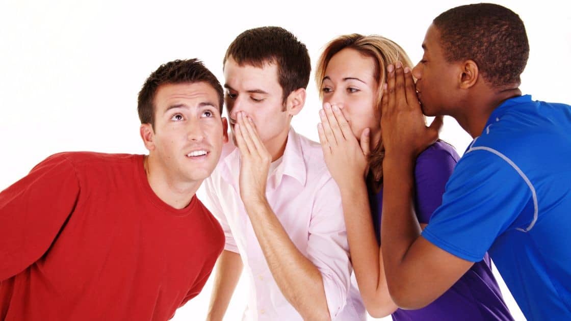 Hispanic man whispering secrets to diverse group of friends, gossiping, sharing news, social communication, friendship, fun, socializing, group interaction.