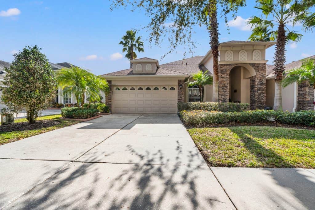 Elegant Tampa home with lush landscaping and modern design elements, perfect for comfortable living.