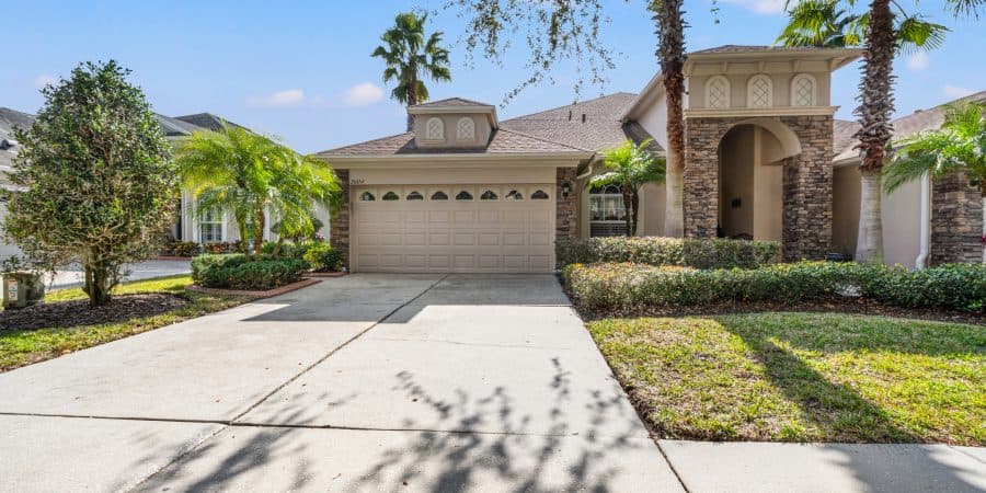Elegant Tampa home with lush landscaping and modern design elements, perfect for comfortable living.