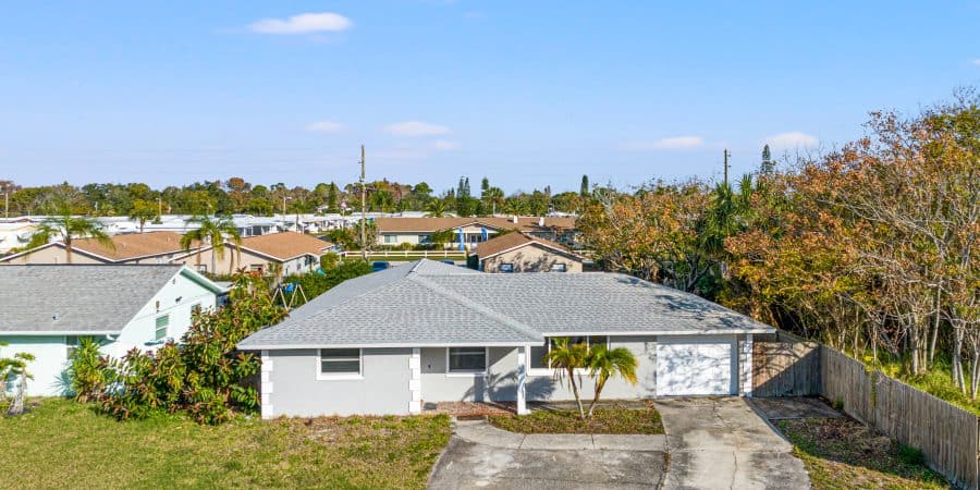Modern single-story home with spacious driveway in Tampa, Florida.