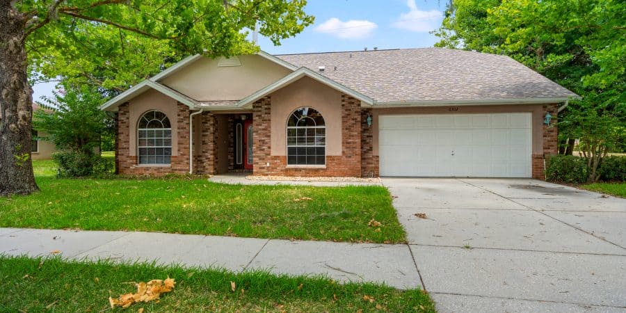 Brick and stucco single-family home with a well-maintained front yard in Tampa, FL.