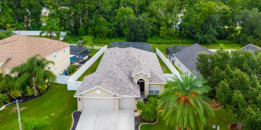 Spacious single-family home in Tampa with landscaped yard and lush greenery.