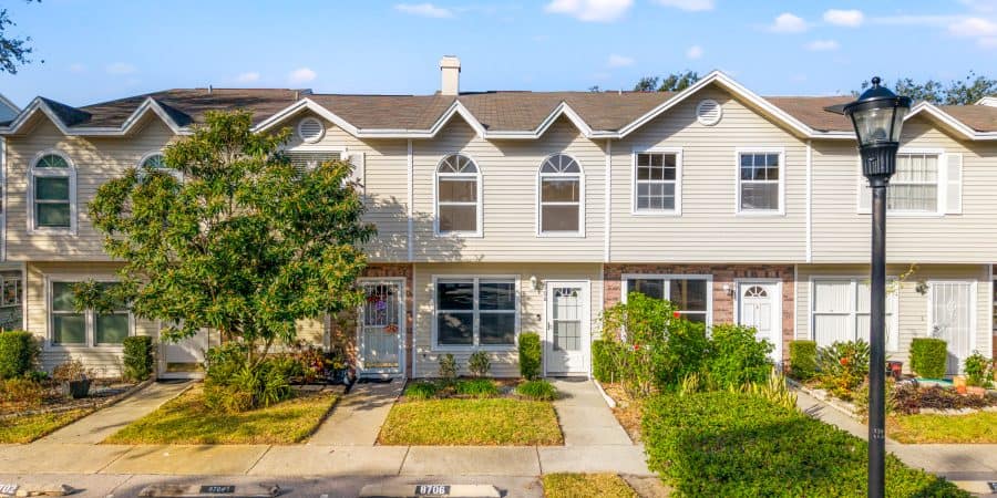Modern townhouse in Tampa with well-maintained landscaping and suburban street view.
