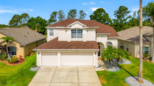 Spacious modern house with a well-manicured lawn and tropical landscaping in Tampa, Florida.