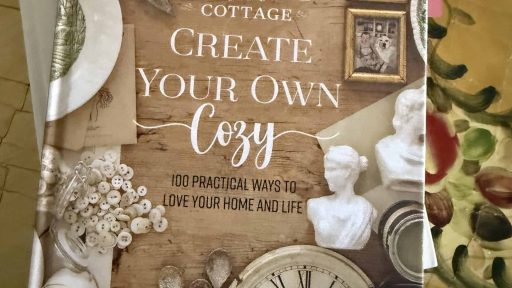 Cozy white cottage decor book on creating a warm home and life.
